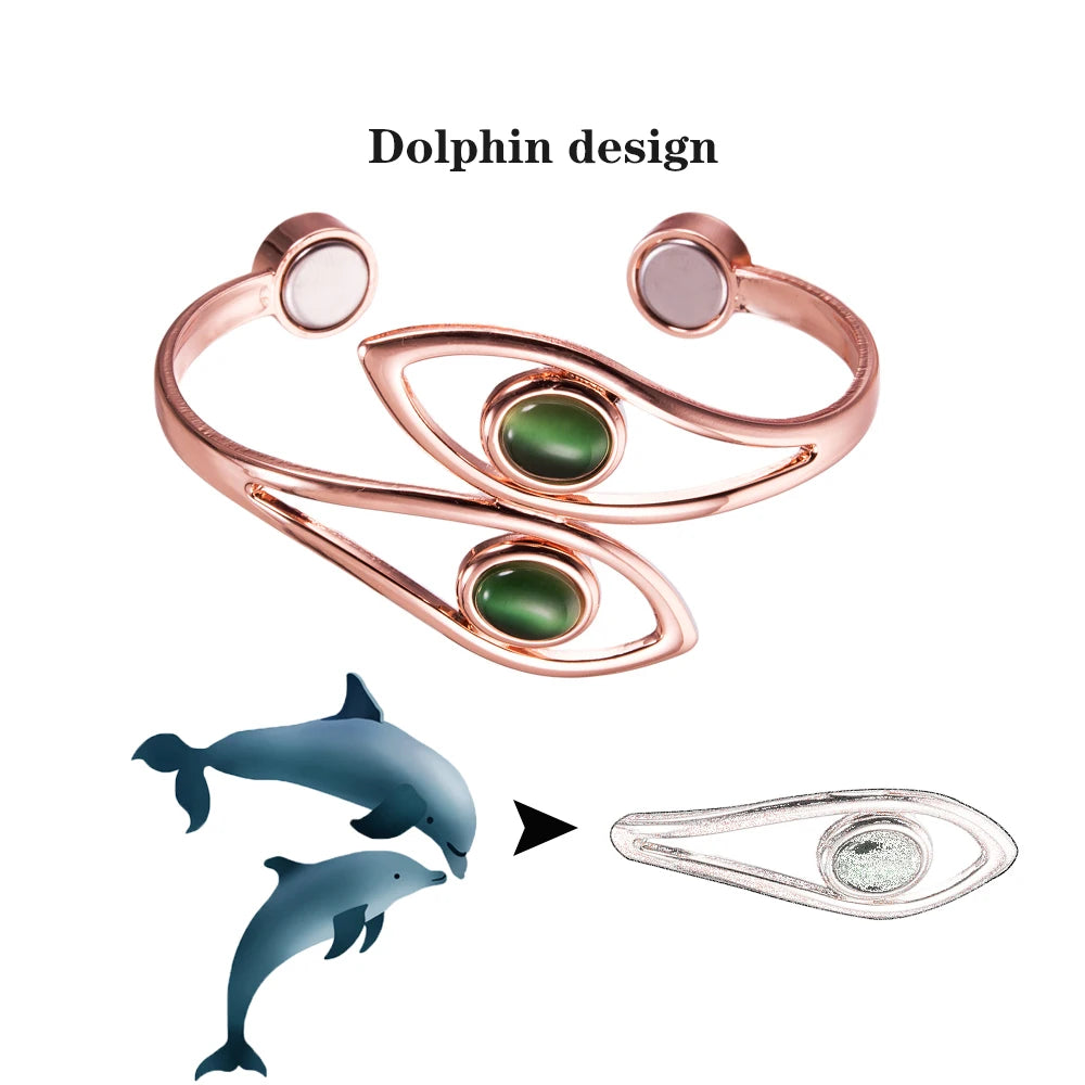 A rose gold cuff bracelet with a dolphin design, featuring two green oval cabochons and two round bezel-set stones, shown alongside a graphic explaining the dolphin motif.