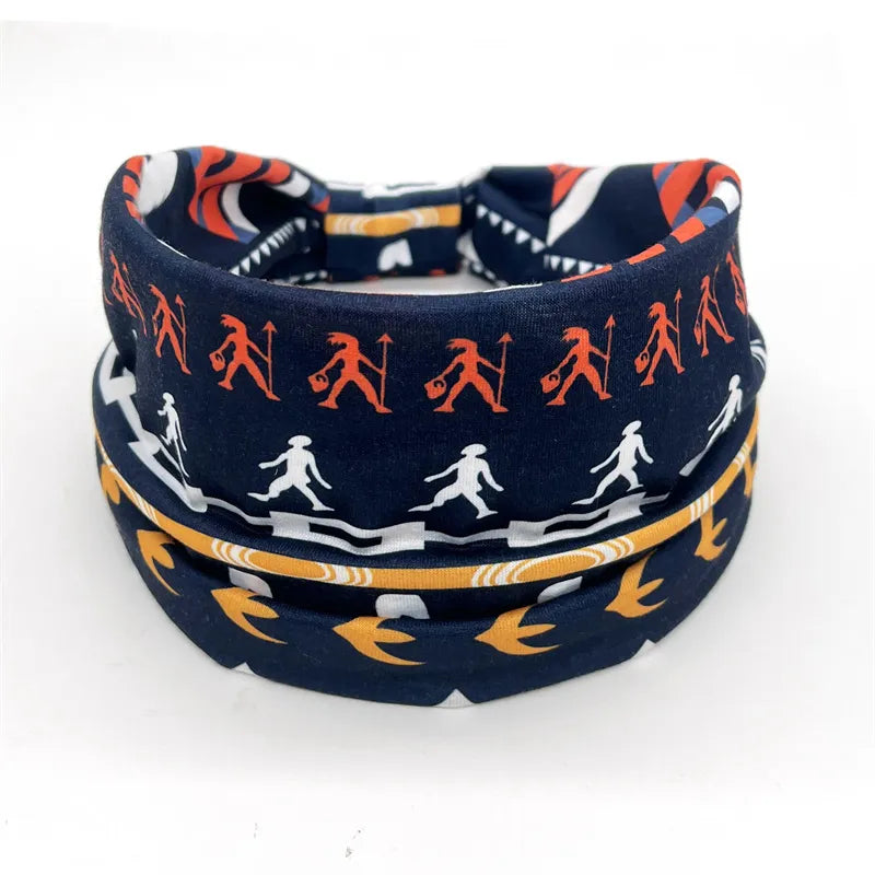Navy blue yoga headband with unique tribal and silhouette designs, ideal for braids, locs, sisterlocks, and dreadlocks. Stretchy and stylish fit.