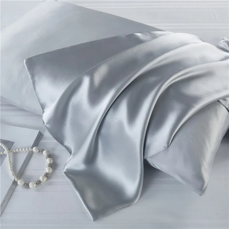 Sleek silver natural mulberry silk pillowcase for locs. Soft, breathable, and designed to reduce hair friction for a smooth sleeping experience.