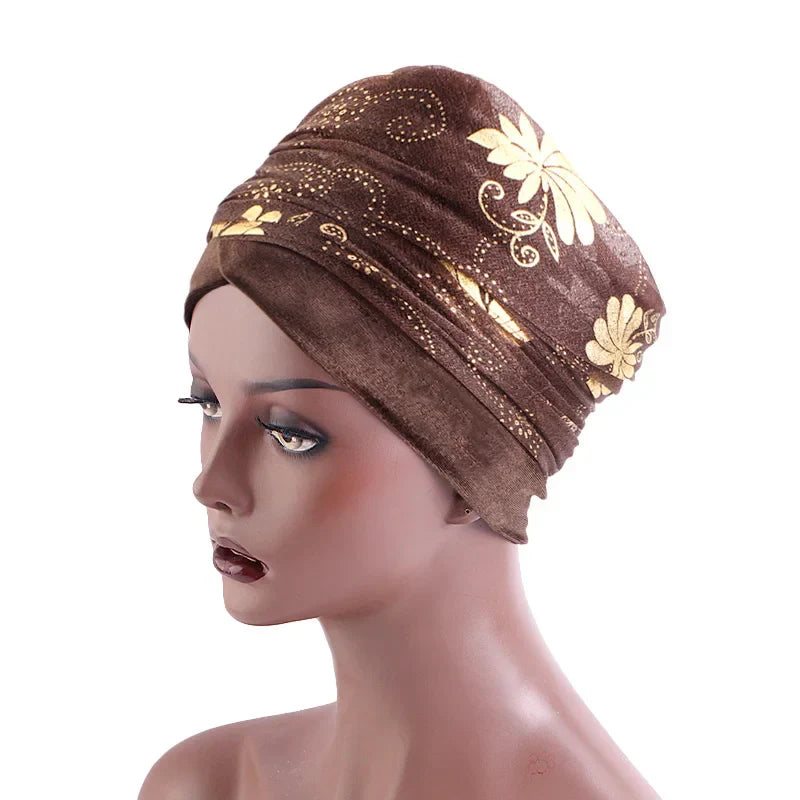 Brown Regal Amethyst Adorned Headwrap with intricate gold floral patterns, displayed on a mannequin. A sophisticated headwrap for women.