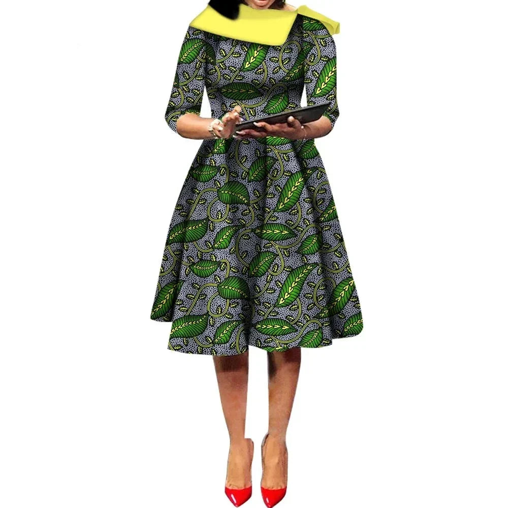 African Ankara Wax Print Midi Dress in green with intricate leaf patterns, featuring a fitted waist and flared skirt.
