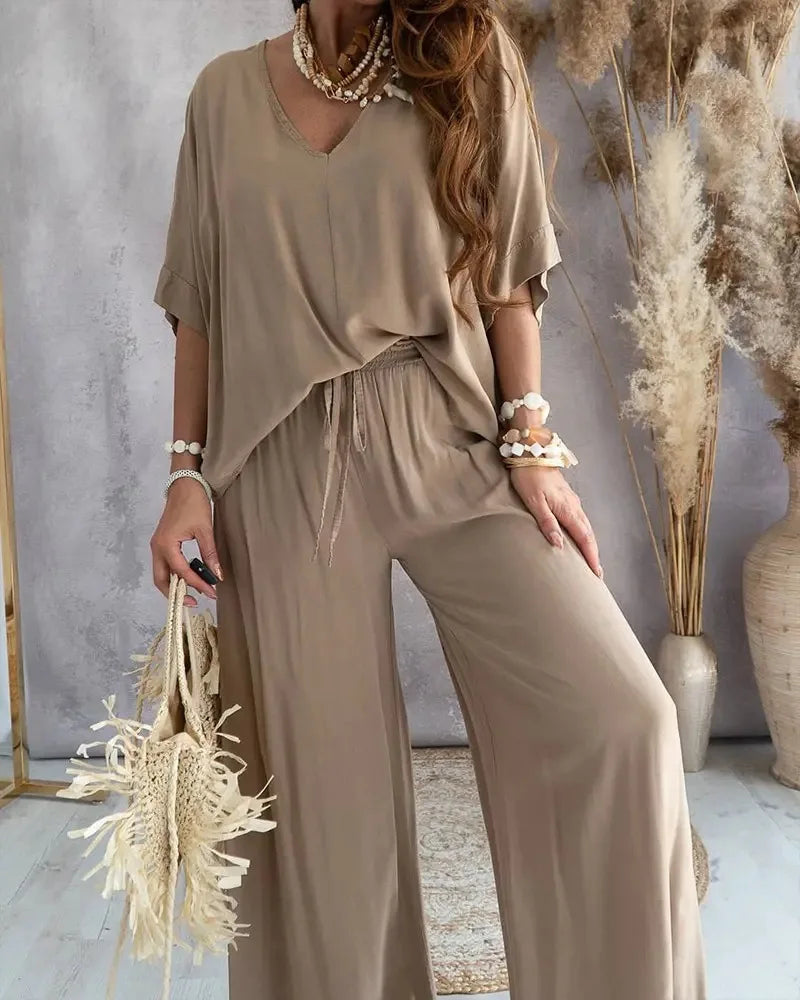 Beige casual two-piece set for women with a relaxed V-neck top and wide-leg pants. A chic and comfy outfit for everyday wear.
