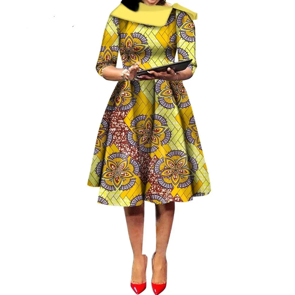African Ankara Wax Print Midi Dress in yellow with intricate floral and lattice patterns, featuring a classic midi length.