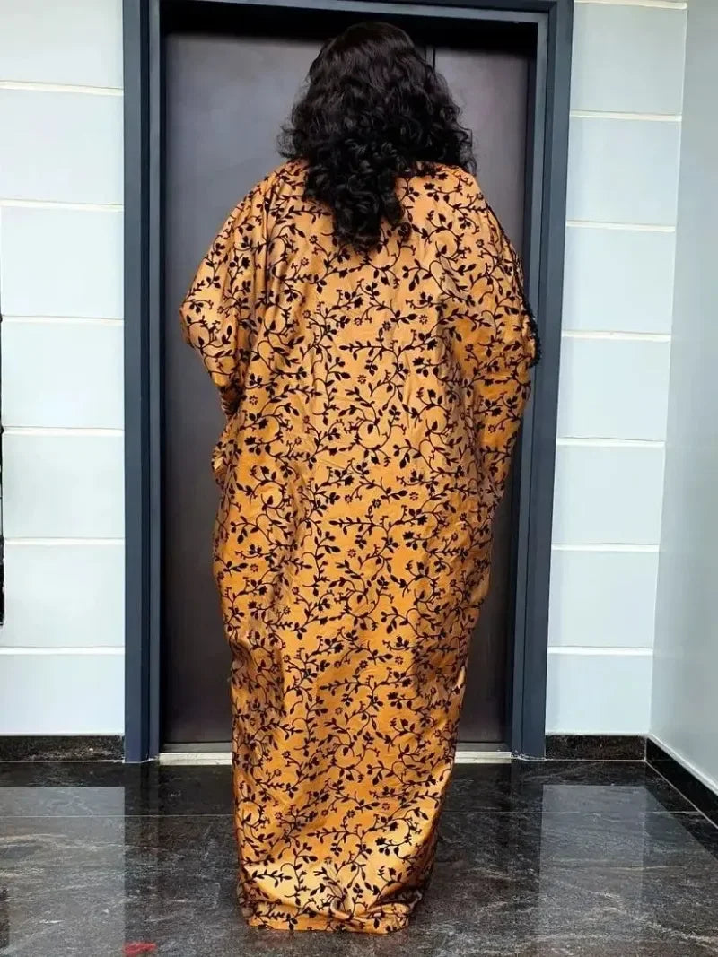 Back view of a brown and black floral abaya maxi dress with flare sleeves, showcasing its flowing silhouette and intricate pattern details.