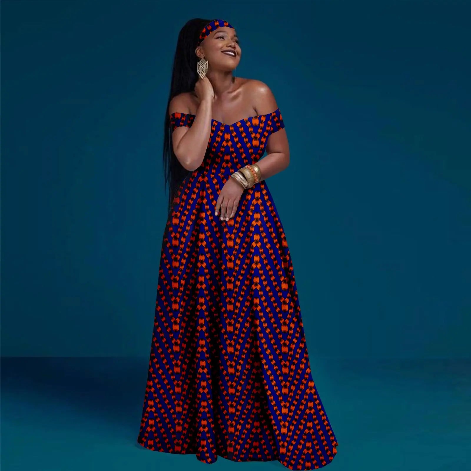 Woman wearing a blue and orange patterned dress against a blue background