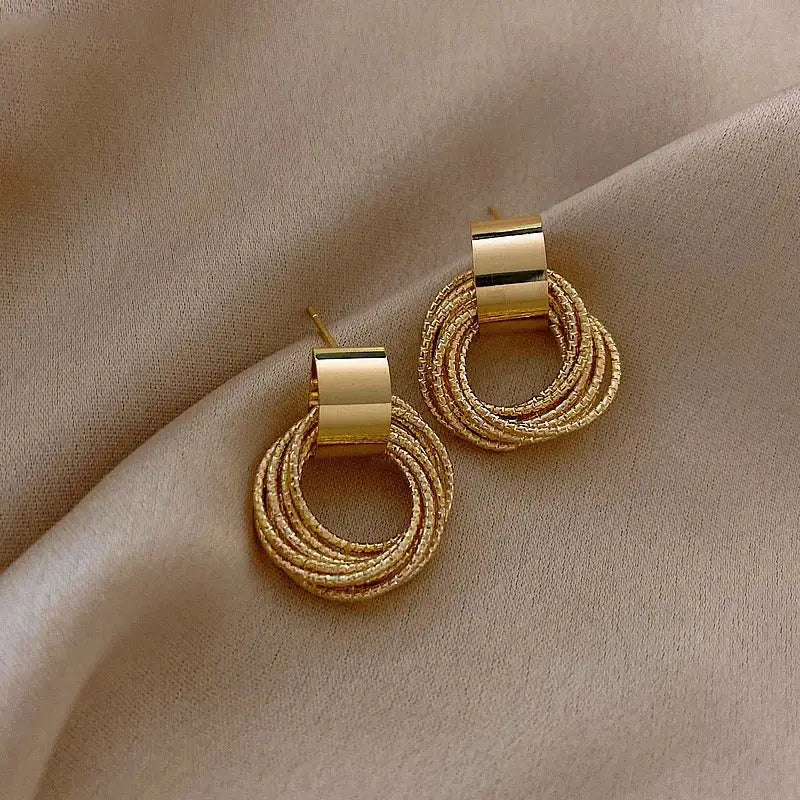 Gold-tone textured stud earrings with a circular rope design. Elegant and stylish modern vintage earrings for women.