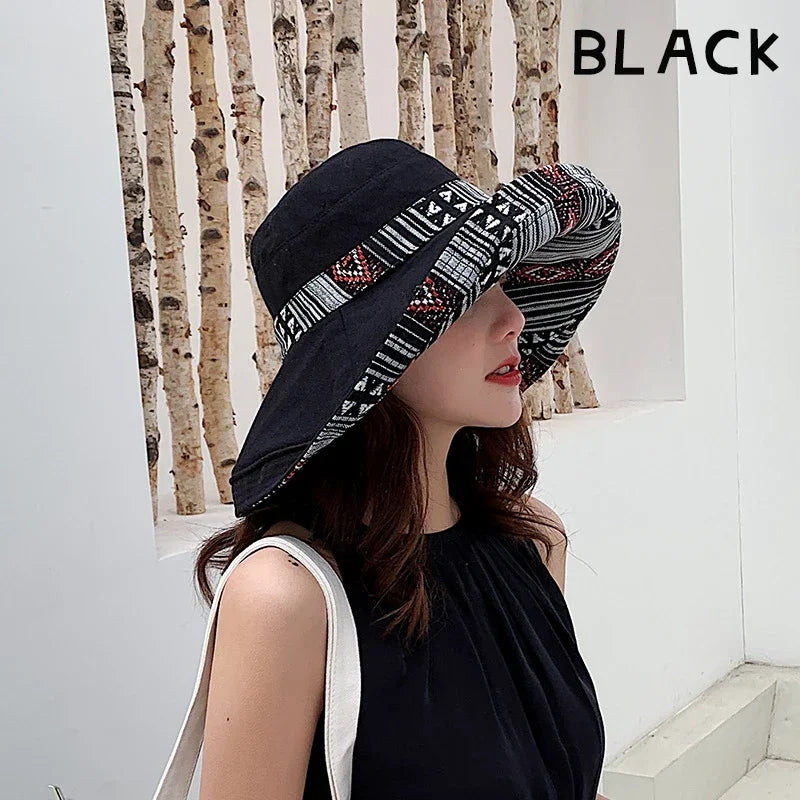 Black reversible sun hat with tribal pattern lining, offering dual-sided style for versatile wear.