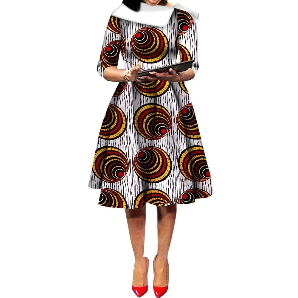 African Ankara Wax Print Midi Dress with bold circular patterns in red, yellow, and black on a white background.