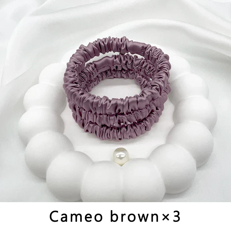 Three-piece set of cameo brown mulberry silk elastic hair bands. Ideal for frizz-free, gentle styling of natural and loc’d hair.