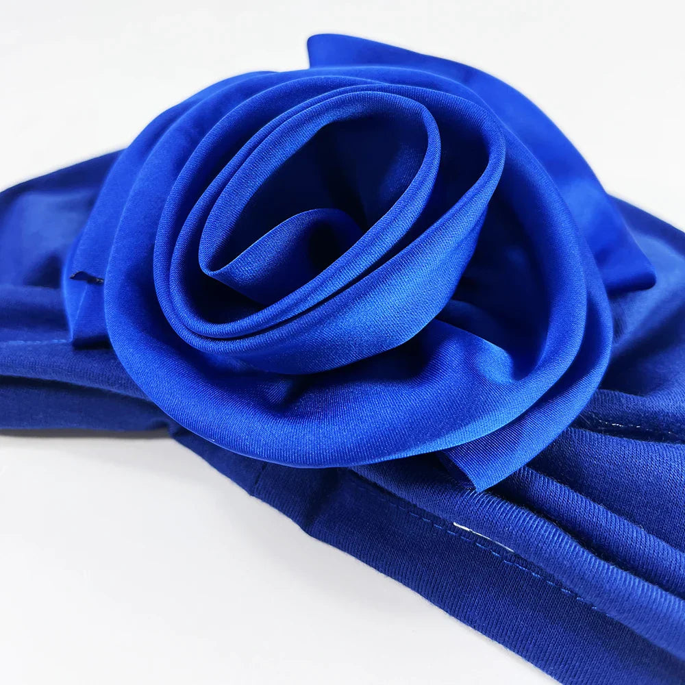 Close-up of royal blue floral stretch bandana head wrap showcasing the intricate fabric rose detail. Soft and stretchy for comfort.