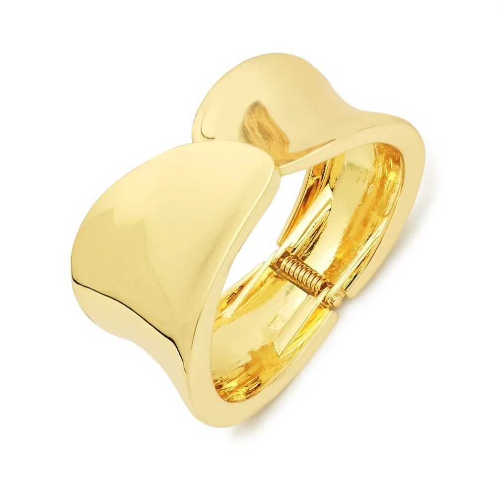 Gold wide cuff bracelet with a sleek, curved design. A bold and elegant accessory for special occasions.