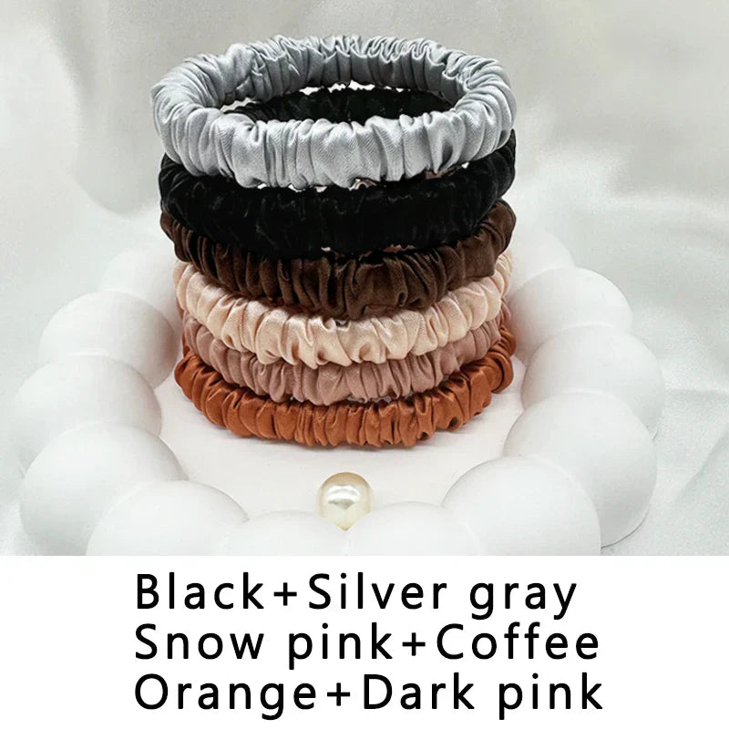 Six-pack of silk elastic hair bands in black, silver gray, snow pink, coffee, orange, and dark pink. Frizz-free styling for all hair types.