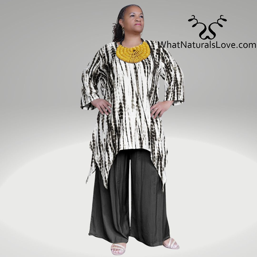 Model wearing a black Shark Hem Top Pants Set with a tie-dye pattern, accessorized with a bold yellow necklace.