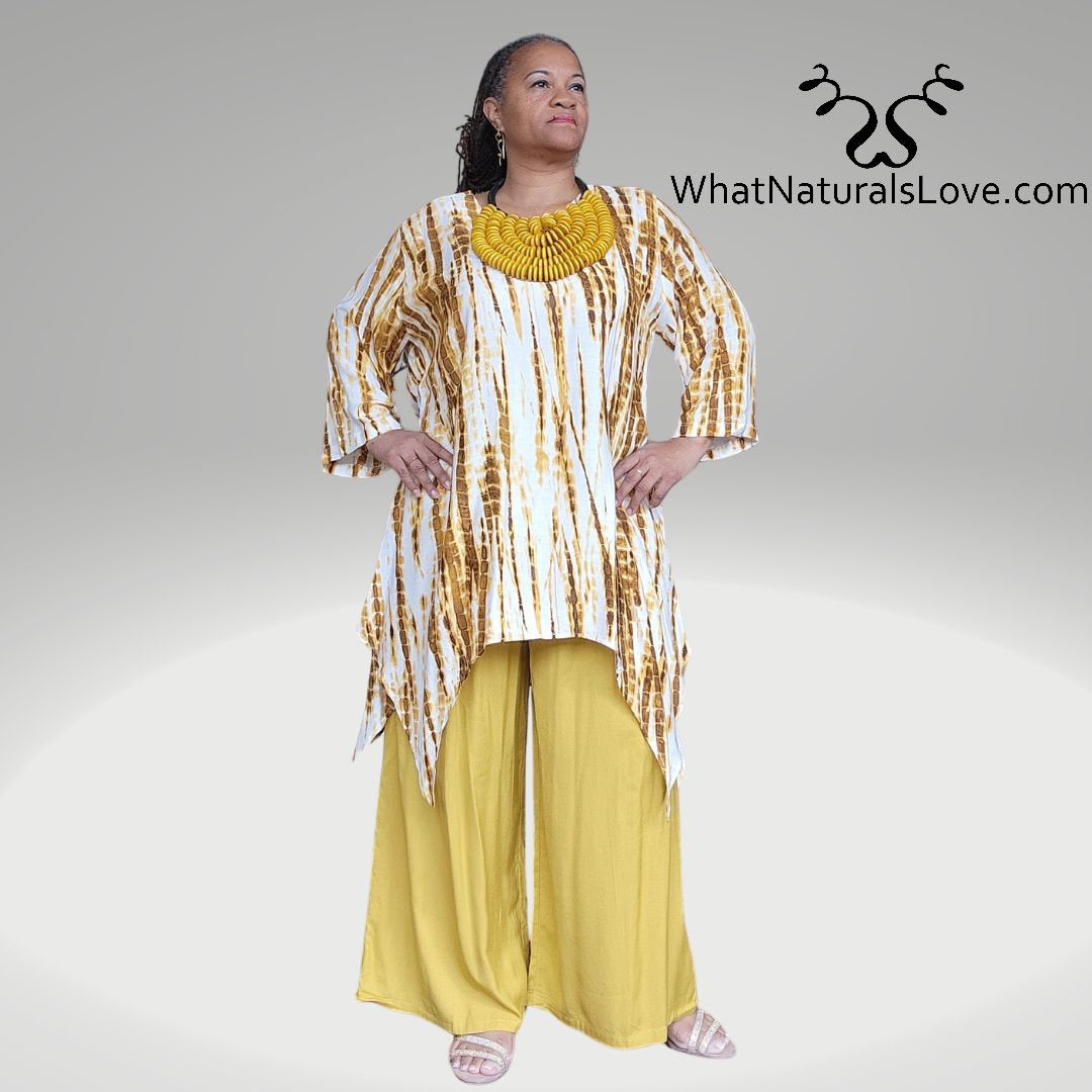 Model wearing a mustard yellow Shark Hem Top Pants Set with a tie-dye pattern, accessorized with a bold yellow necklace.