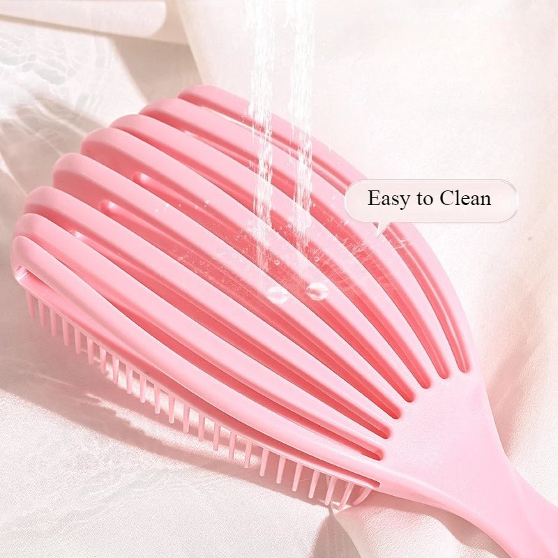 the pink shell shape detangling brush under water - easy to clean
