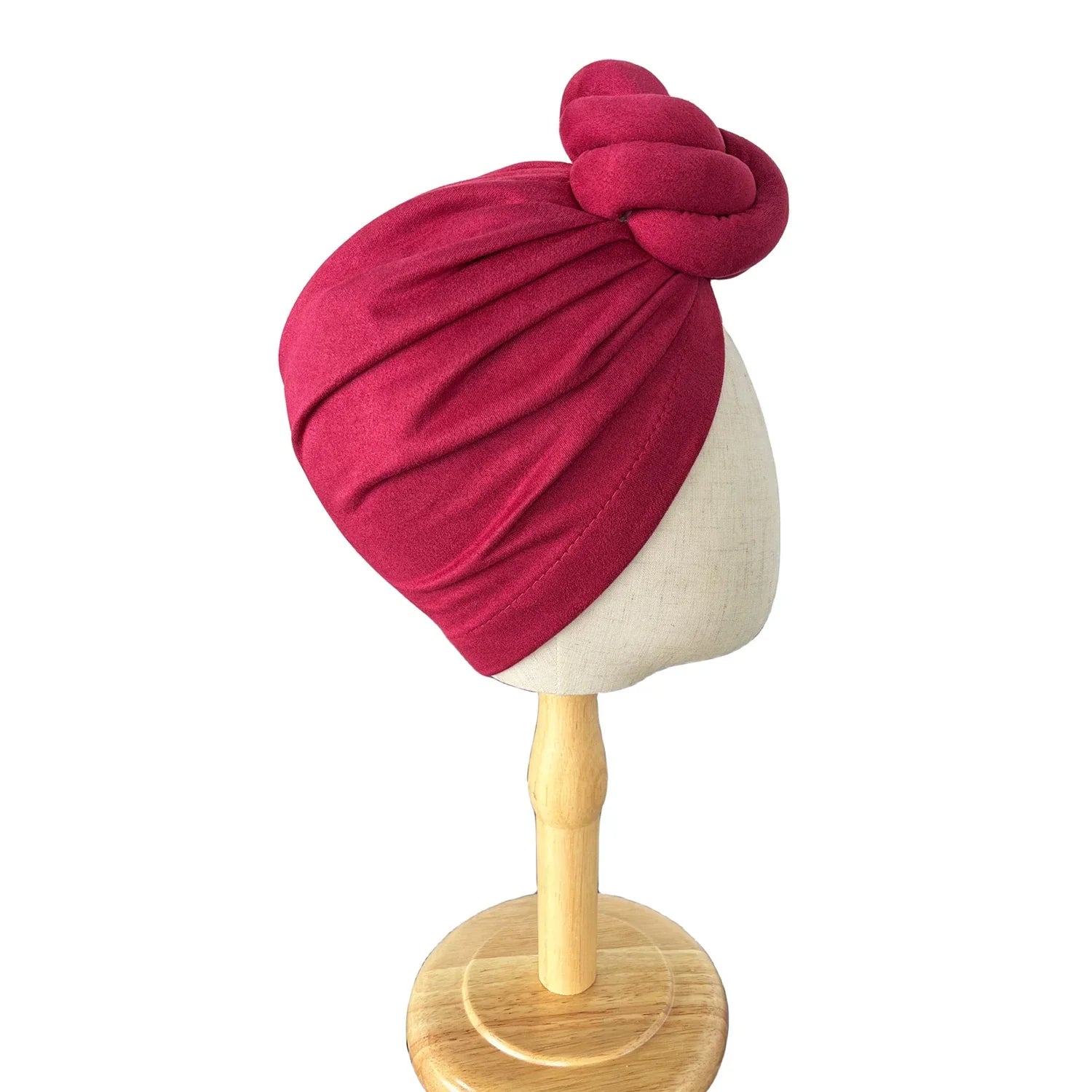 Side view of dark pink soft knotted turban headwrap on a mannequin, highlighting its pleated texture and secure fit.