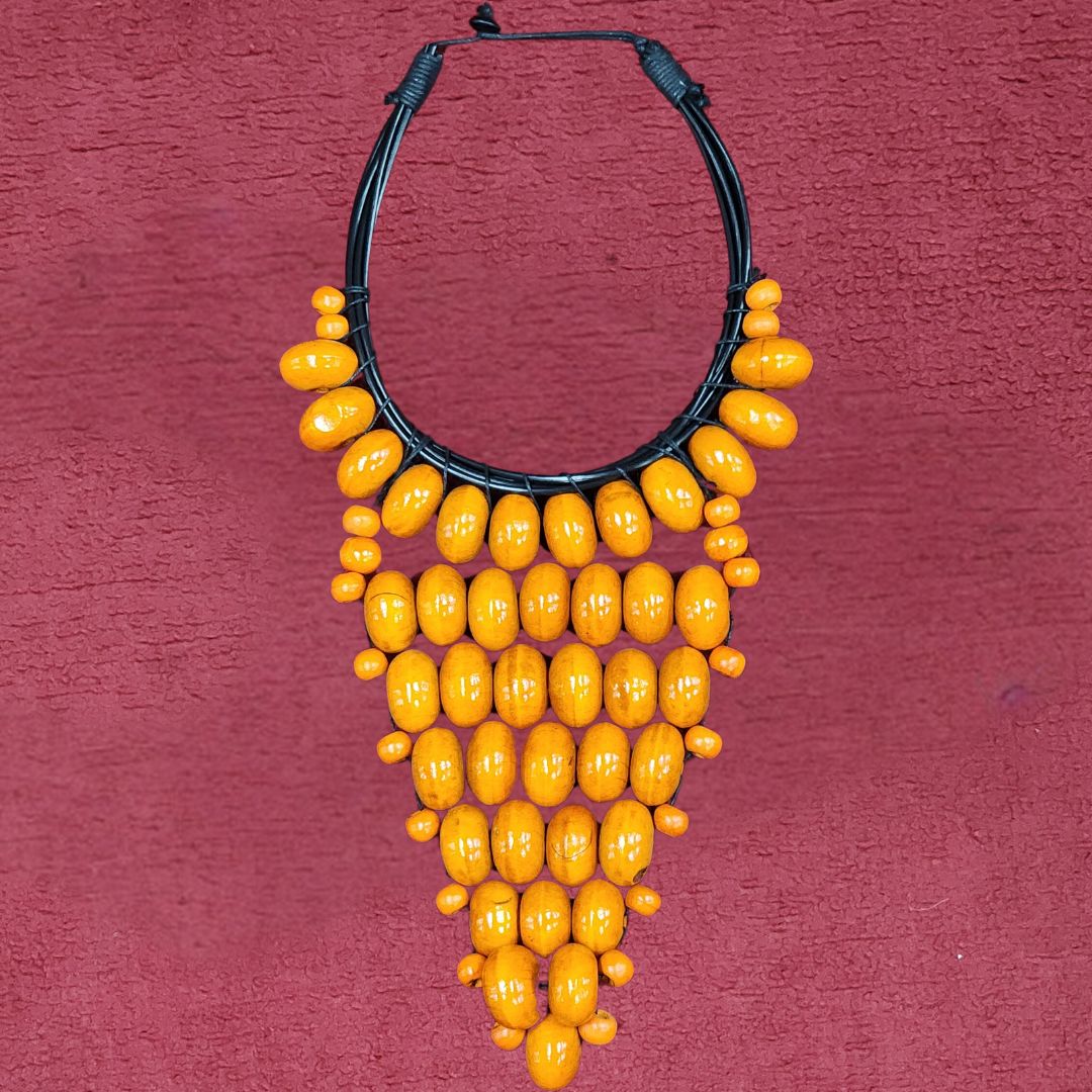 Solar Flare Beaded Necklace featuring vibrant orange wooden beads in a bold, triangular design. Perfect statement piece for Memorial Day 2024.