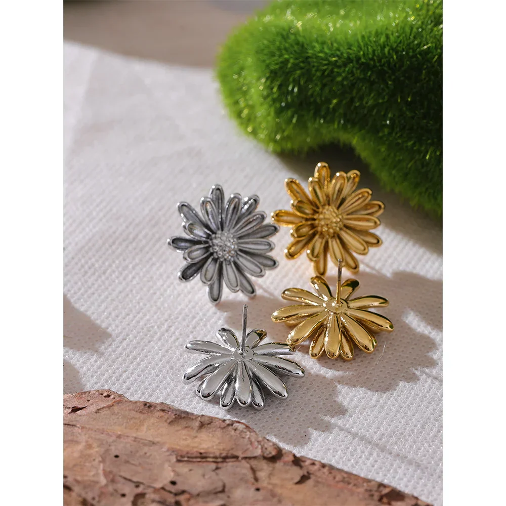 Gold and silver stainless steel flower stud earrings displayed together, highlighting their intricate petal details. Elegant button stud earrings for women’s jewelry collection.