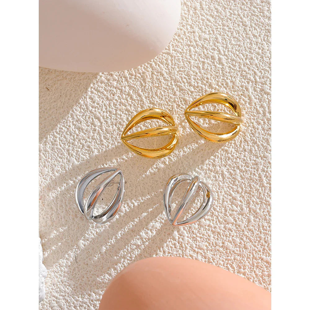 Gold and silver stainless steel half-round geometric hollow stud earrings displayed on textured surface. Stylish vintage earrings for women.