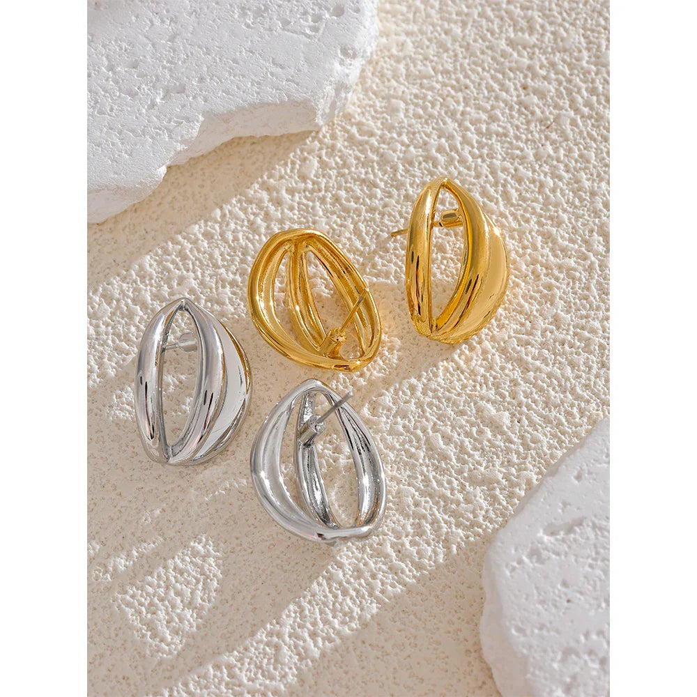 Gold and silver stainless steel half-round geometric hollow stud earrings arranged on a neutral background. Perfect for vintage jewelry lovers.