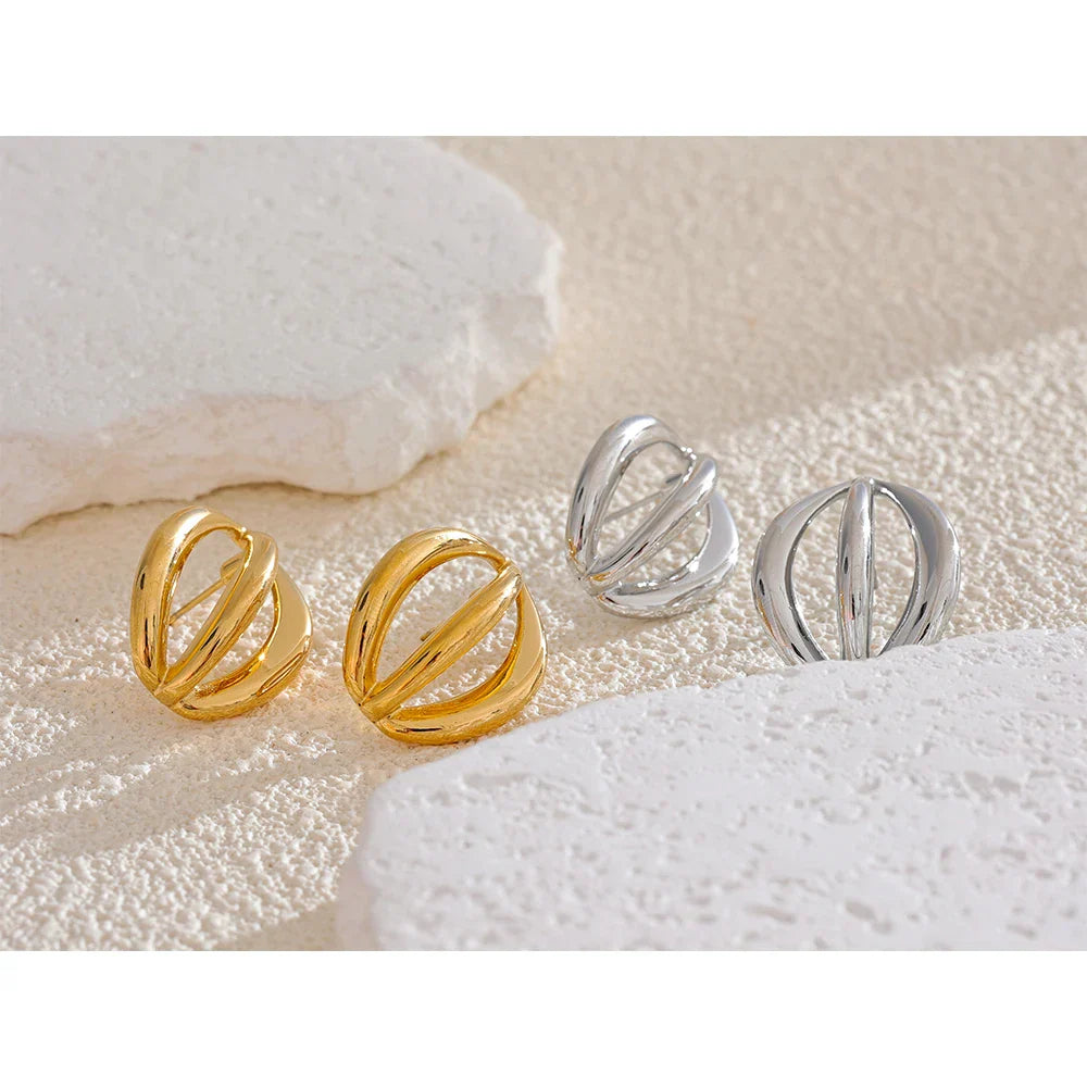 Gold and silver stainless steel half-round geometric hollow stud earrings displayed on a textured surface. A modern and stylish accessory.