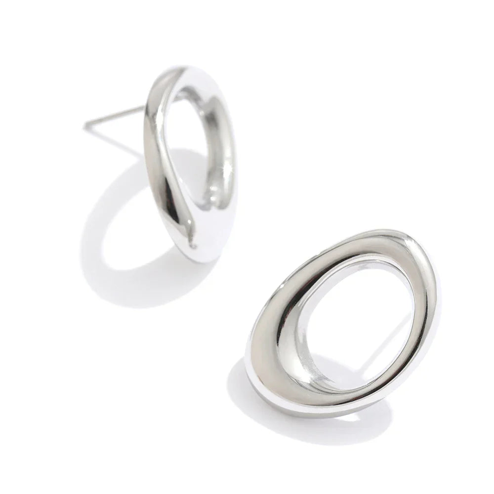 Silver stainless steel round hollow stud earrings with a modern and minimalist design. Perfect for everyday wear and vintage-inspired fashion.