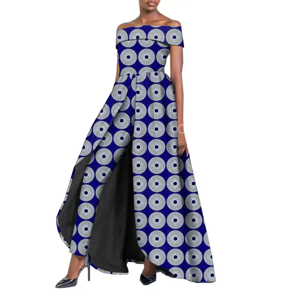 Elegant African pantsuit for women in navy blue and white circular print. Off-shoulder design with a flowing cape, made from 100% cotton for comfort and style.