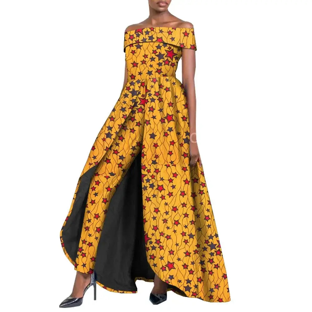 Vibrant African pantsuit for women in yellow and red floral print. Off-shoulder design with a long cape, ideal for elegant and powerful fashion looks.