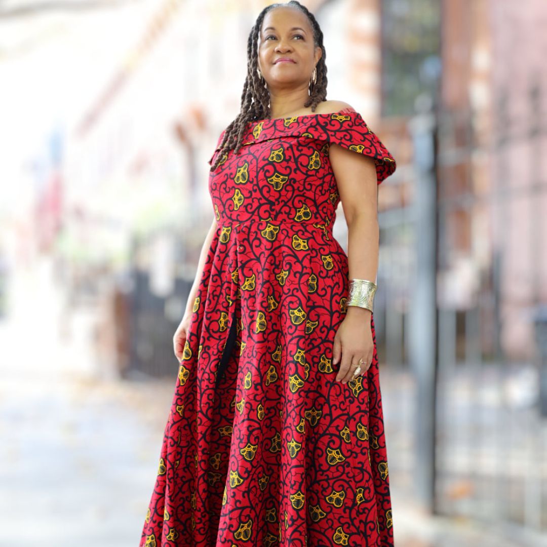 Elegant red African pantsuit for women with an off-shoulder neckline and bold patterns, tailored for a sophisticated and powerful look.