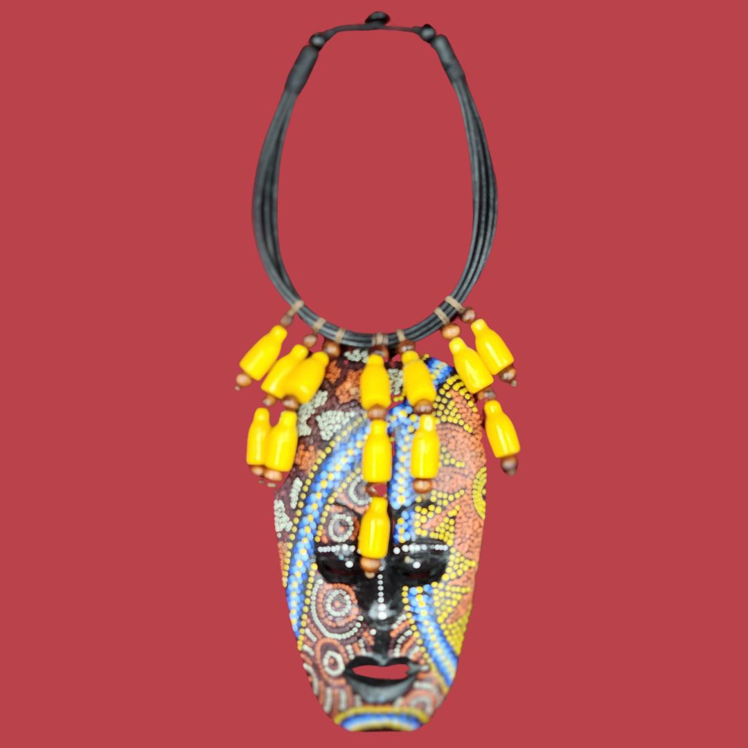 Sunshine Tribal Mask Necklace featuring a vibrant African-inspired wooden mask pendant with intricate beadwork and yellow beaded accents. A unique handmade statement piece for cultural jewelry lovers.