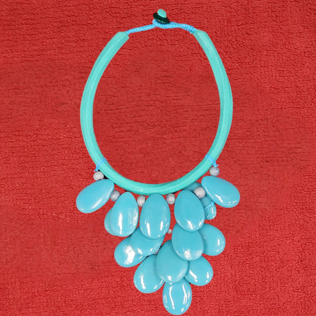 Turquoise Tide Cluster Necklace featuring glossy turquoise beads on a fabric-wrapped band. A bold statement piece for any jewelry collection.