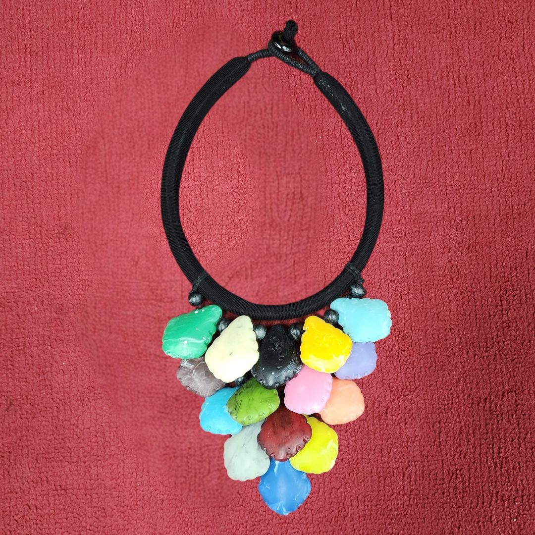 Vivid Petal Bloom Choker featuring multicolored petal-shaped beads on a black cord. Handmade African necklace with wooden beads for a bold statement.