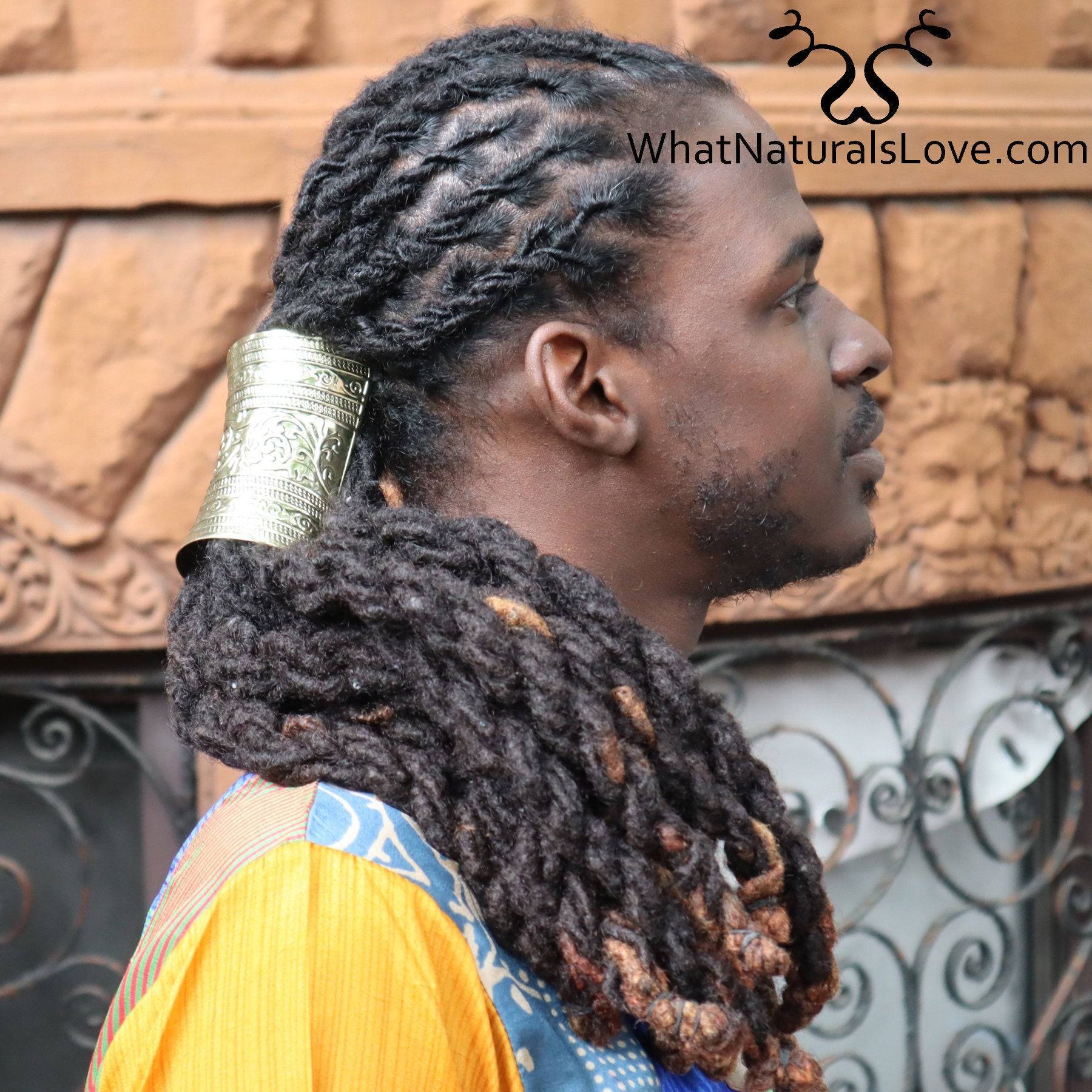 Gold hair cuff securing long dreadlocks in a stylish ponytail, worn by a man in a vibrant outfit. Ideal for locs, Sisterlocks, and braids.