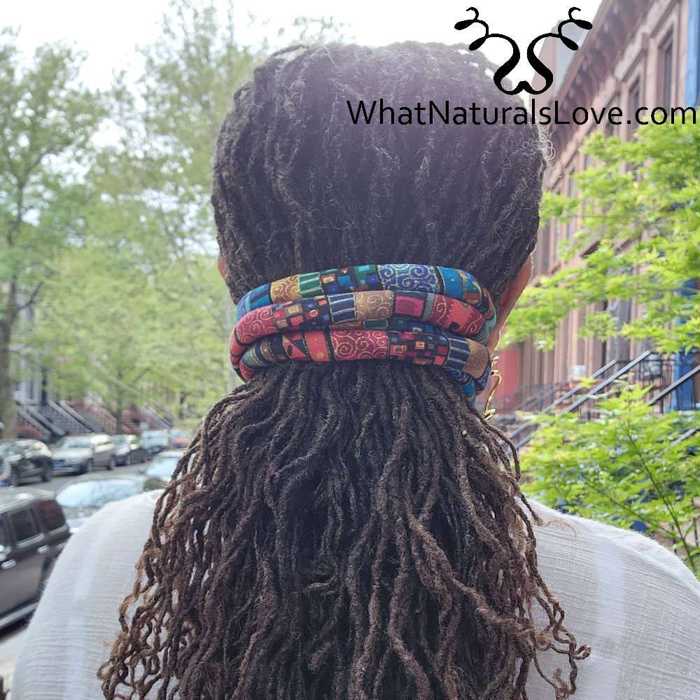 Moldable hair tie securing long locs in a stylish half-up hairstyle. Perfect for dreadlocks, braids, and Sisterlocks with a secure hold.
