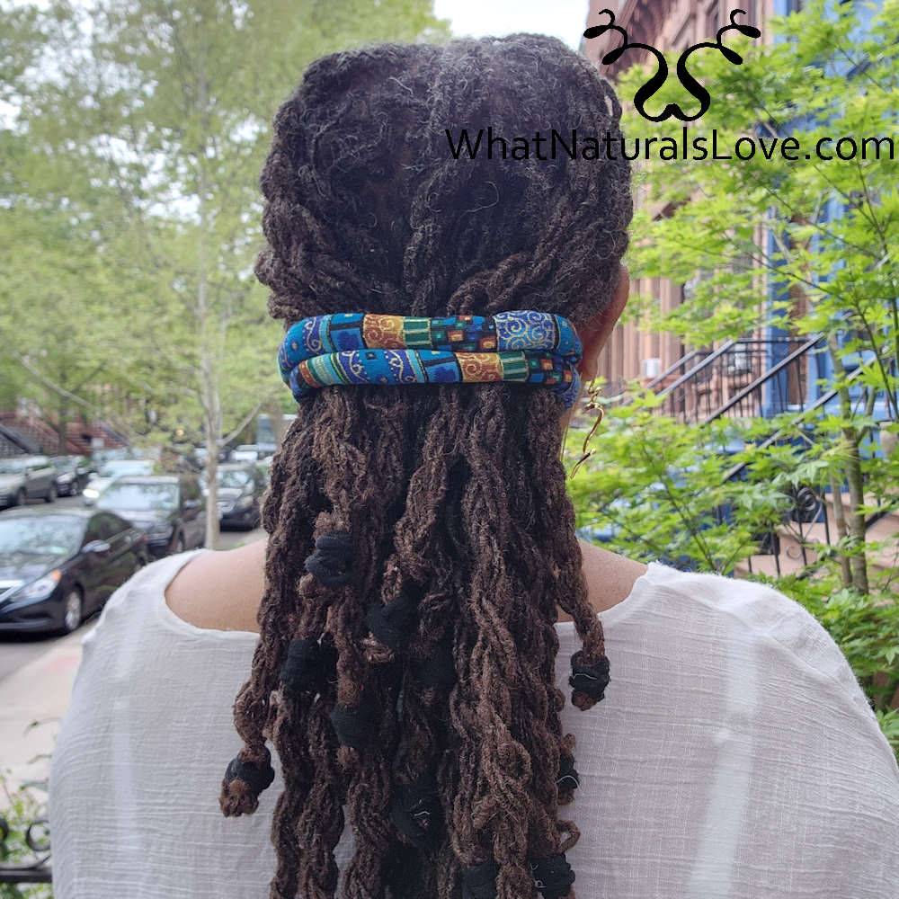 Back view of a woman with locs secured by a blue moldable hair tie. Ideal for Sisterlocks, braids, and afro puffs.