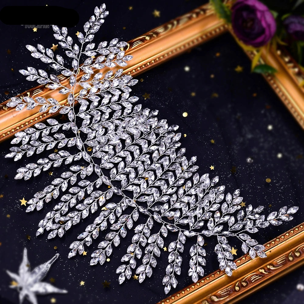 Top view of bridal tiara with crystal leaf design on dark decorative background