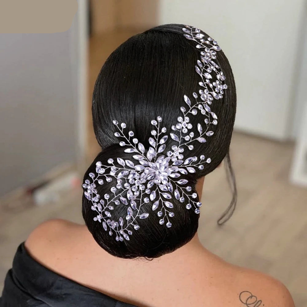 Bridal floral tiara with silver vines styled on a sleek low bun hairstyle.