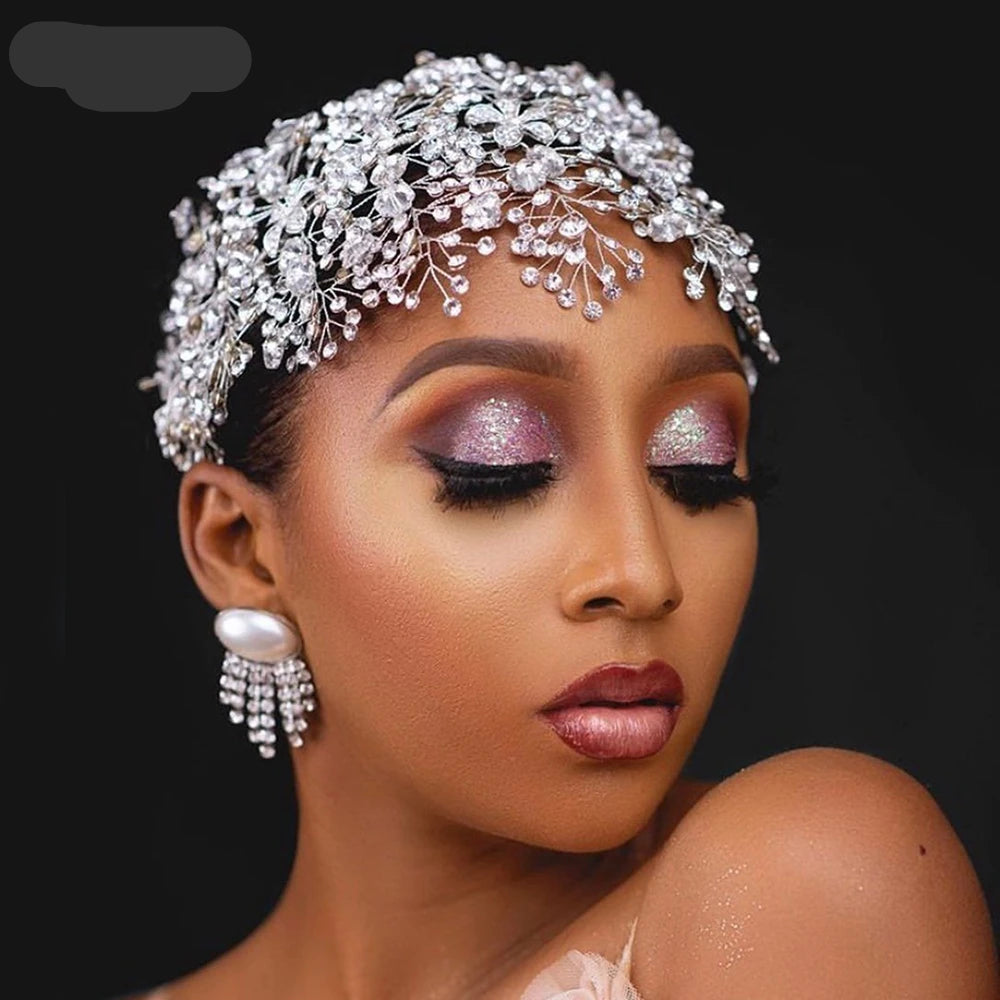 Bride wearing silver floral rhinestone headpiece styled as a full bridal crown.