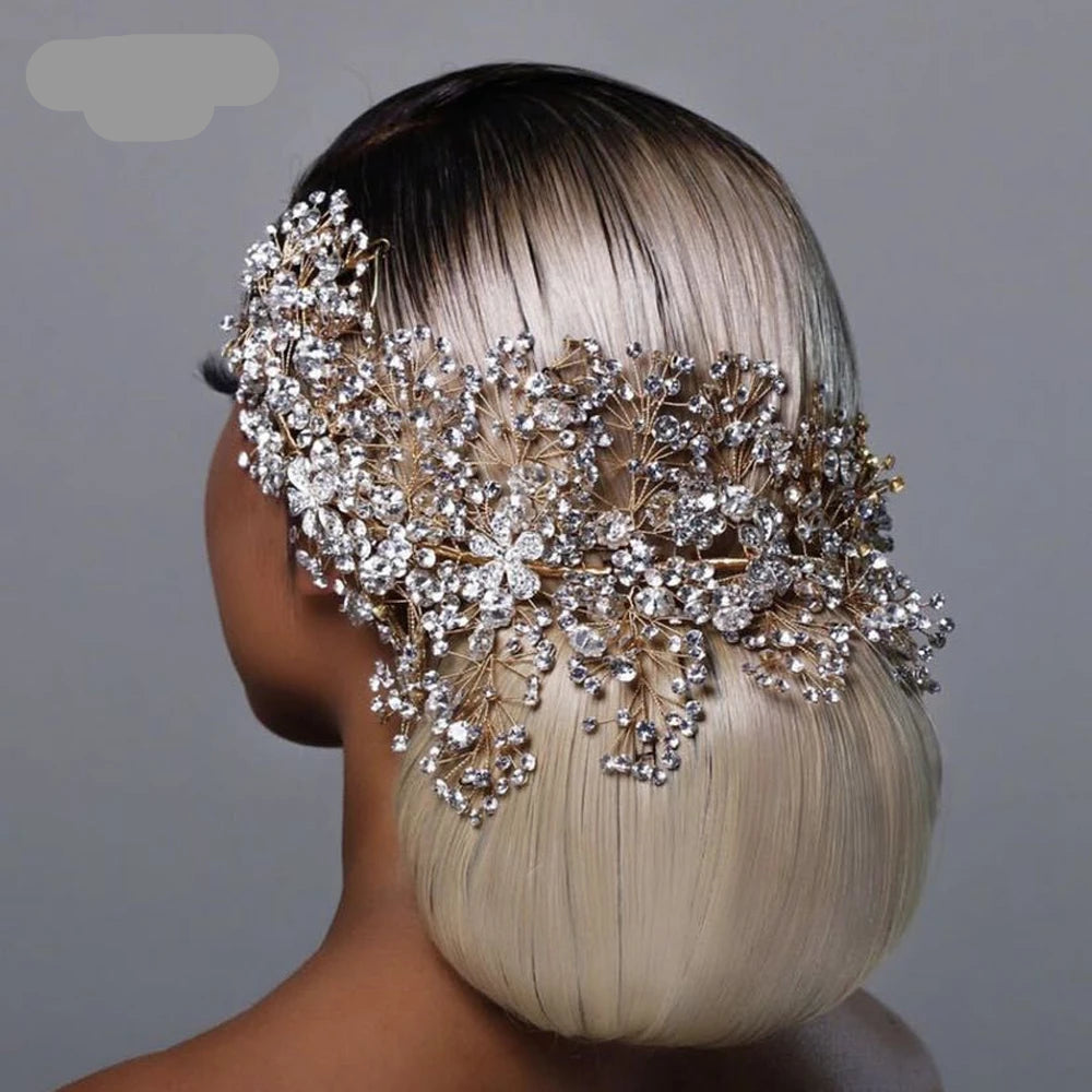 Bride wearing floral rhinestone vine headpiece around sleek low bun hairstyle
