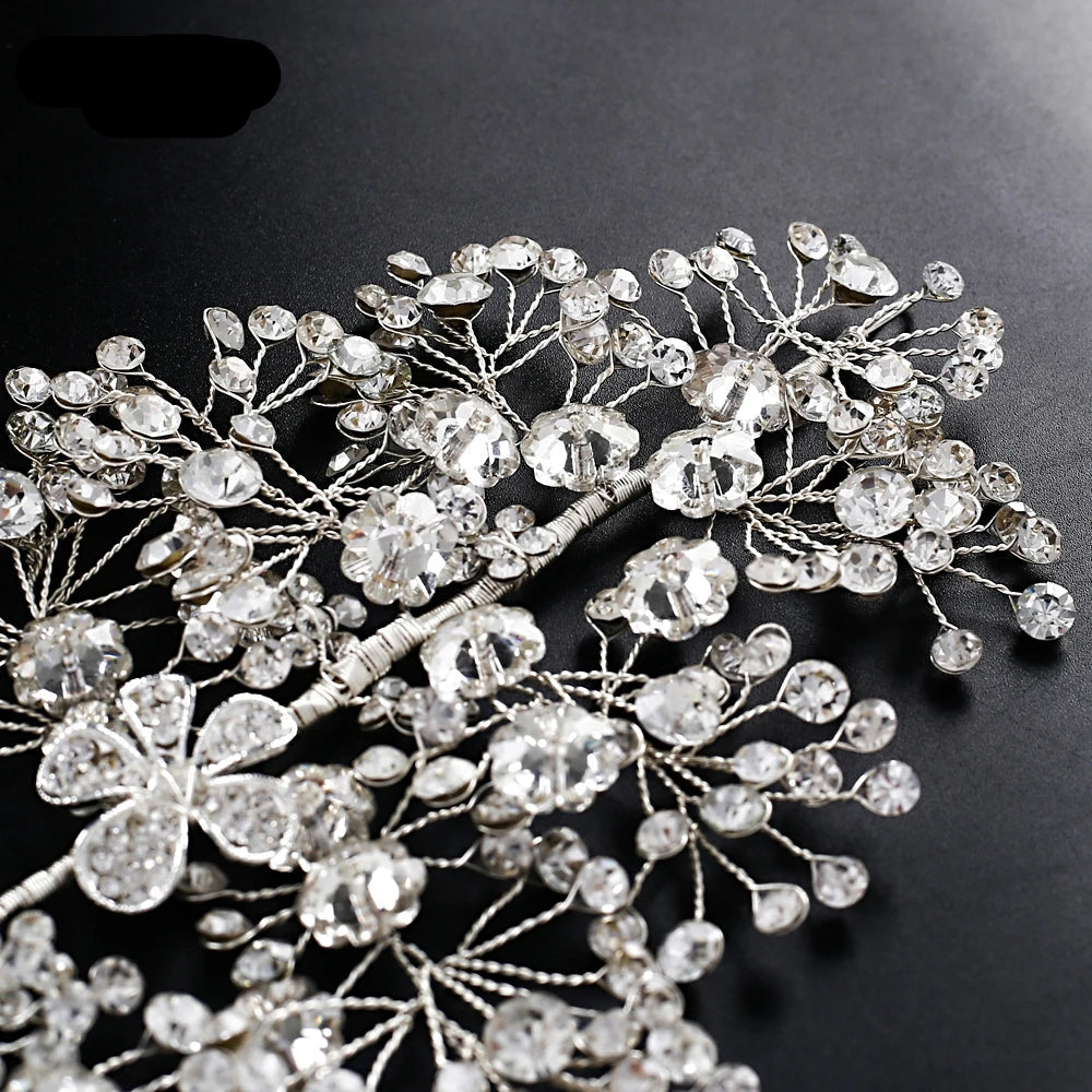 Silver floral rhinestone bridal headpieces displayed on black fabric