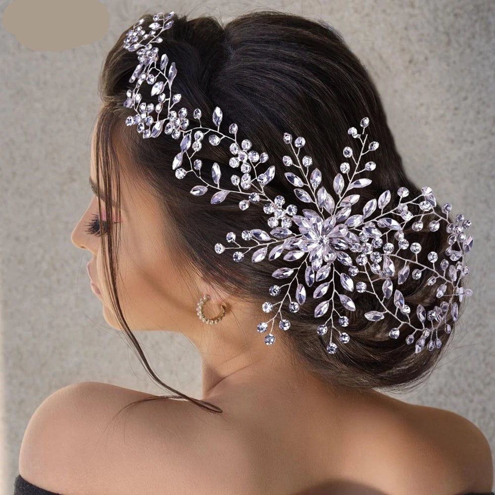 Bride wearing floral tiara with crystal branches on a side profile hairstyle.
