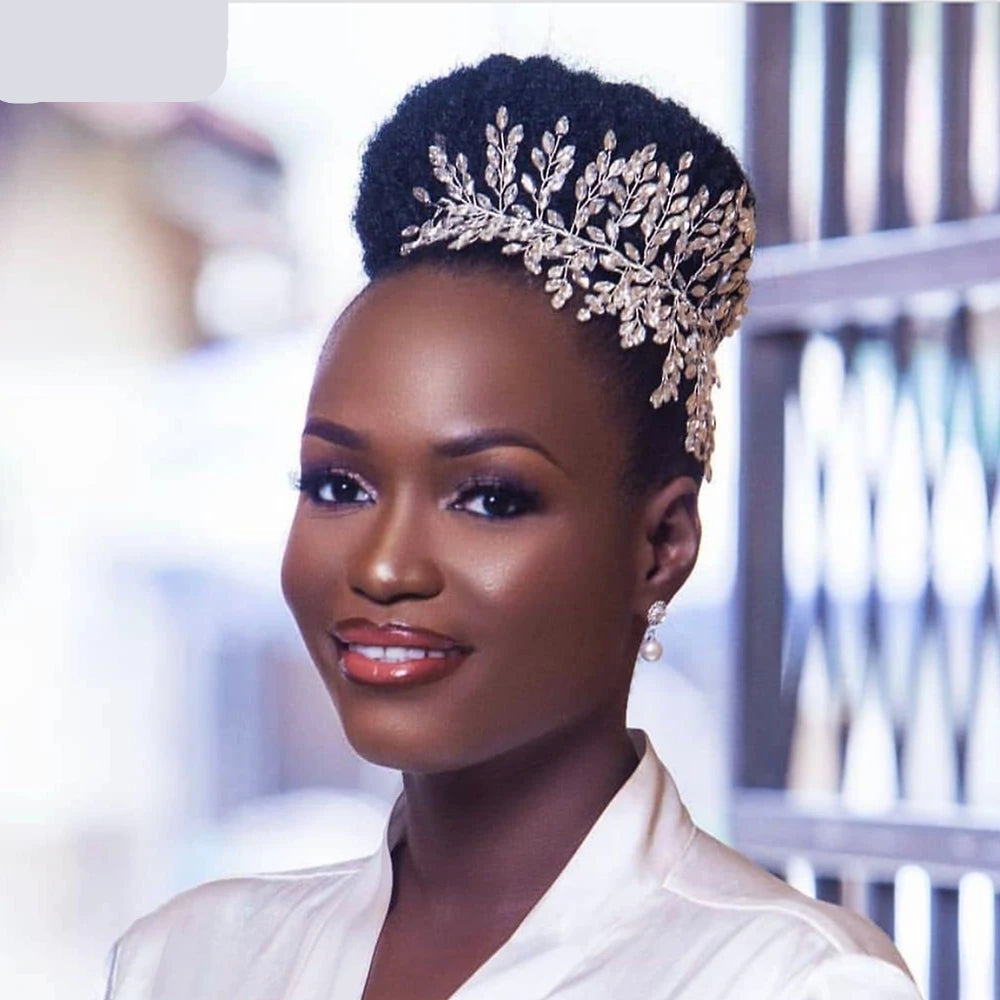 Bride with high bun hairstyle wearing silver boho bridal crown tiara like a queen crown.