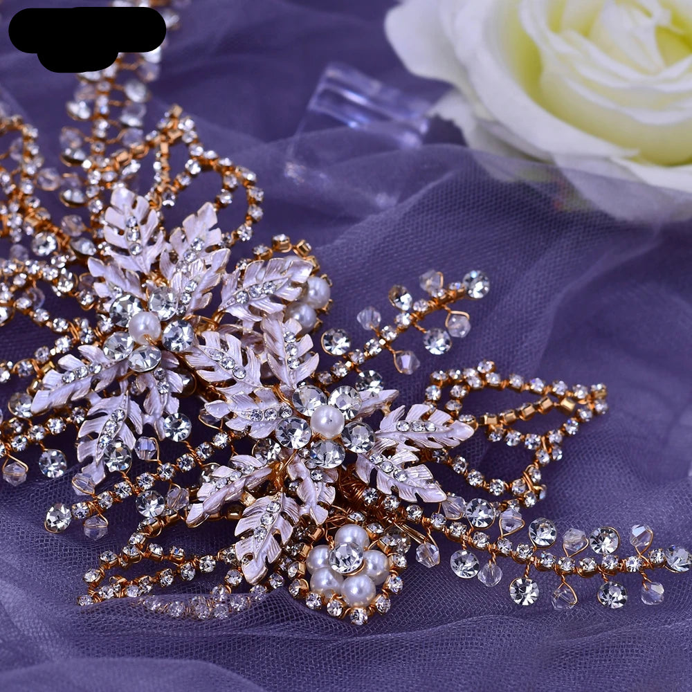 Close-up of rose gold bridal hairpiece with floral crystal and pearl accents on lavender fabric.