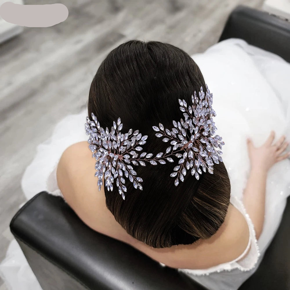 Bride wearing two rose gold floral crystal hairpieces placed symmetrically on elegant updo.