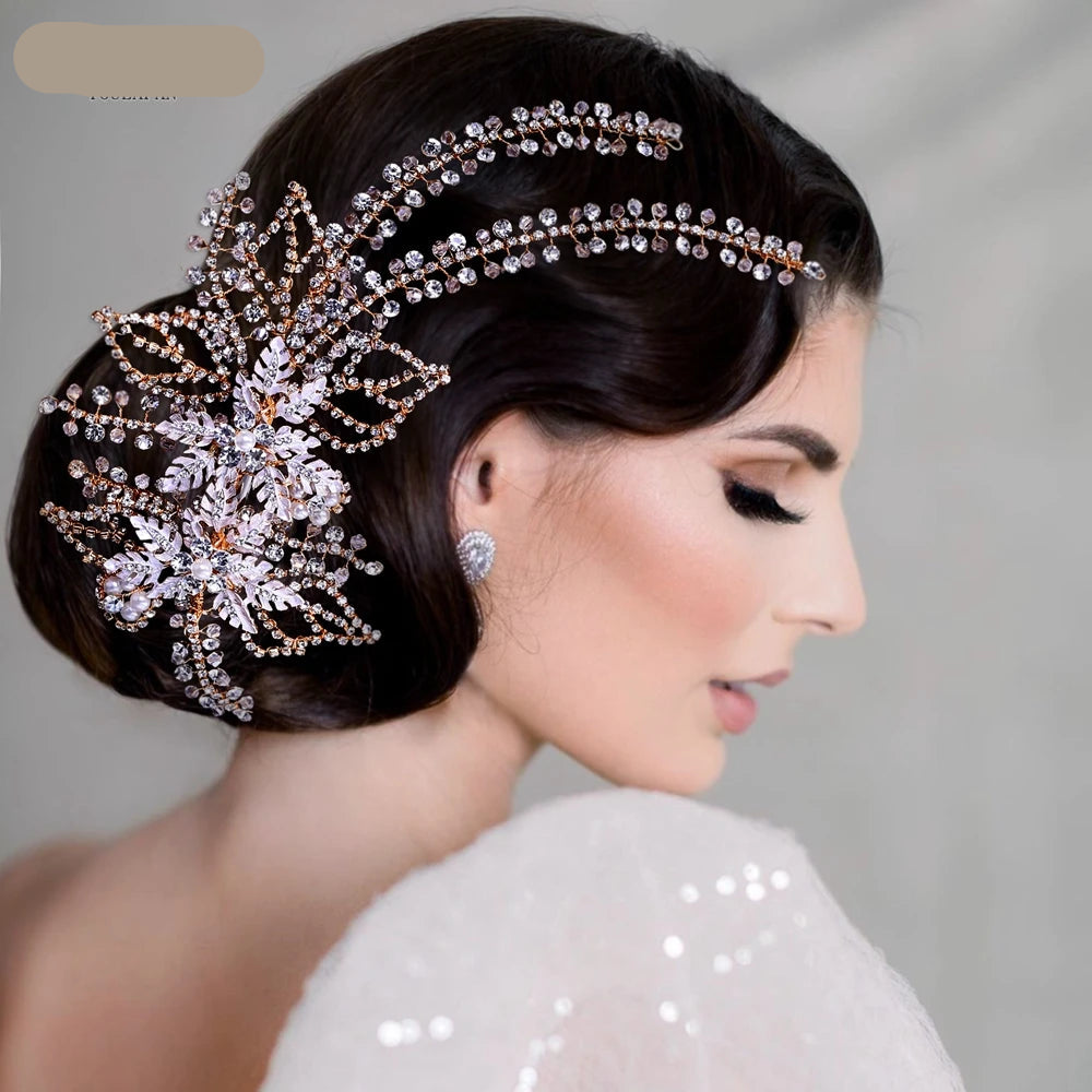 Bride wearing rose gold crystal hairpiece on one side, styled with soft waves and low bun.