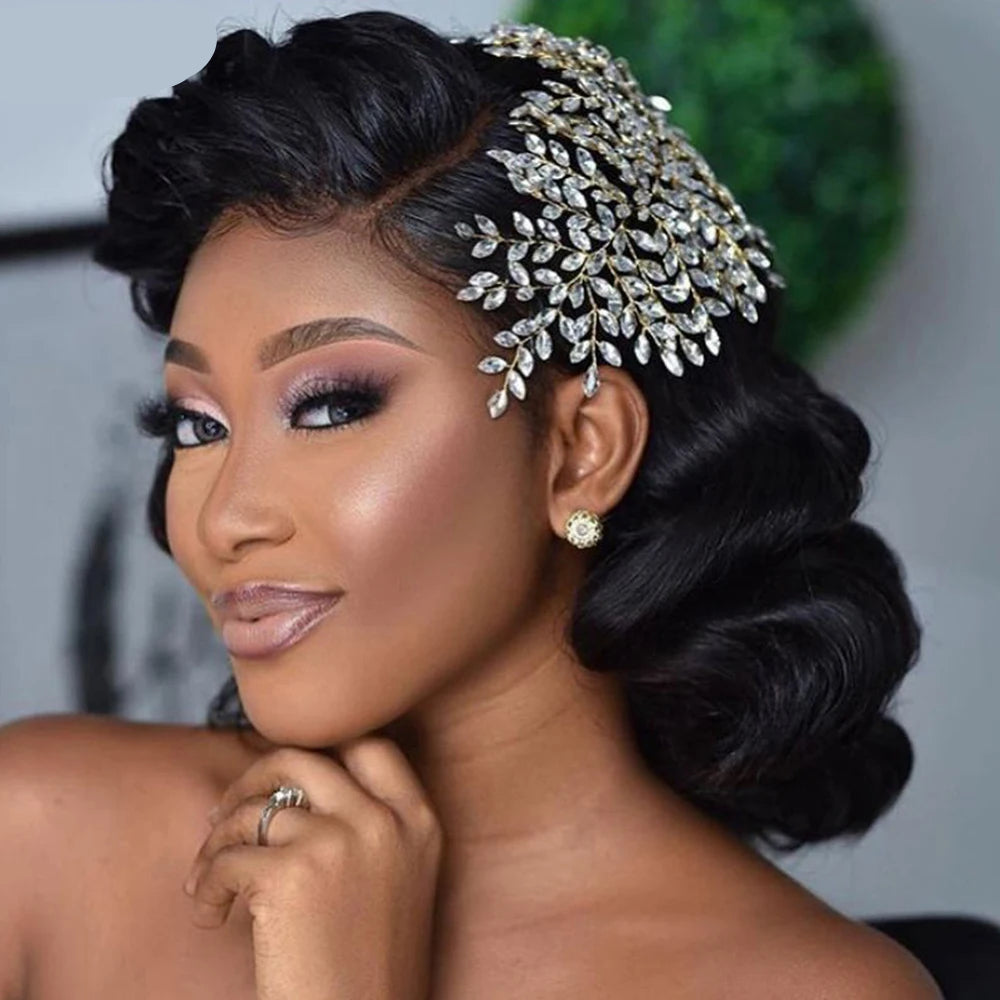 Bride wearing crystal leaf bridal crown styled on side-swept retro curls