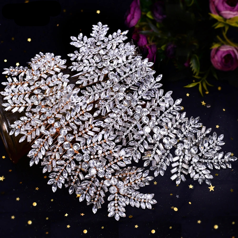 Gold and silver leaf crystal bridal headpieces displayed together on dark starry fabric.