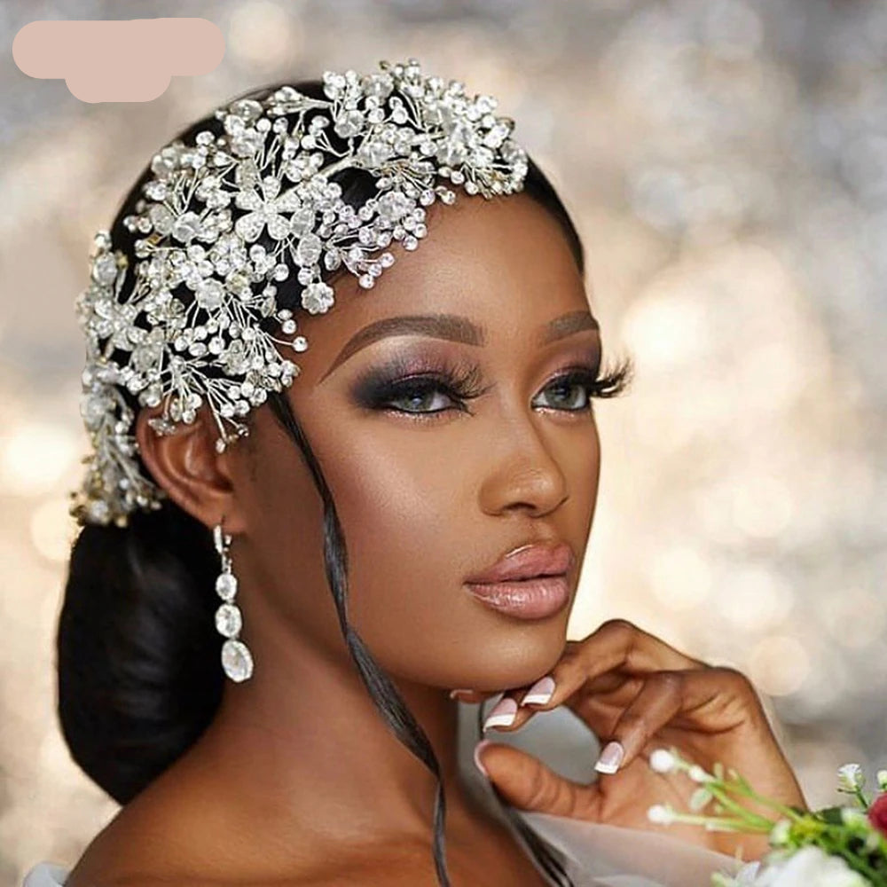 Bride wearing silver floral rhinestone bridal headpiece styled with elegant updo