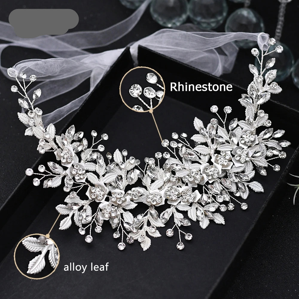 Close-up of silver bridal headpiece with alloy leaves and sparkling rhinestones