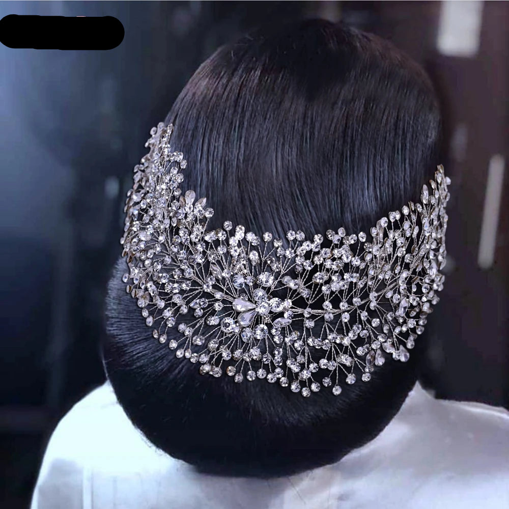 Bride wearing silver full crystal vine hairpiece covering the back of an elegant low bun hairstyle.